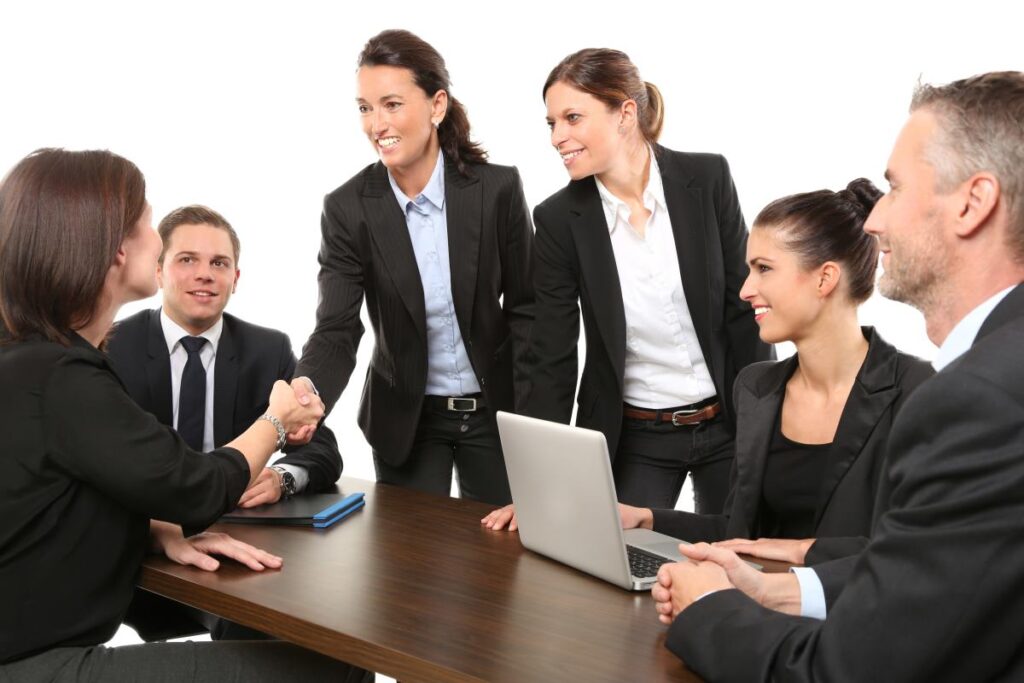 Numerous people sitting around a table having a business meeting