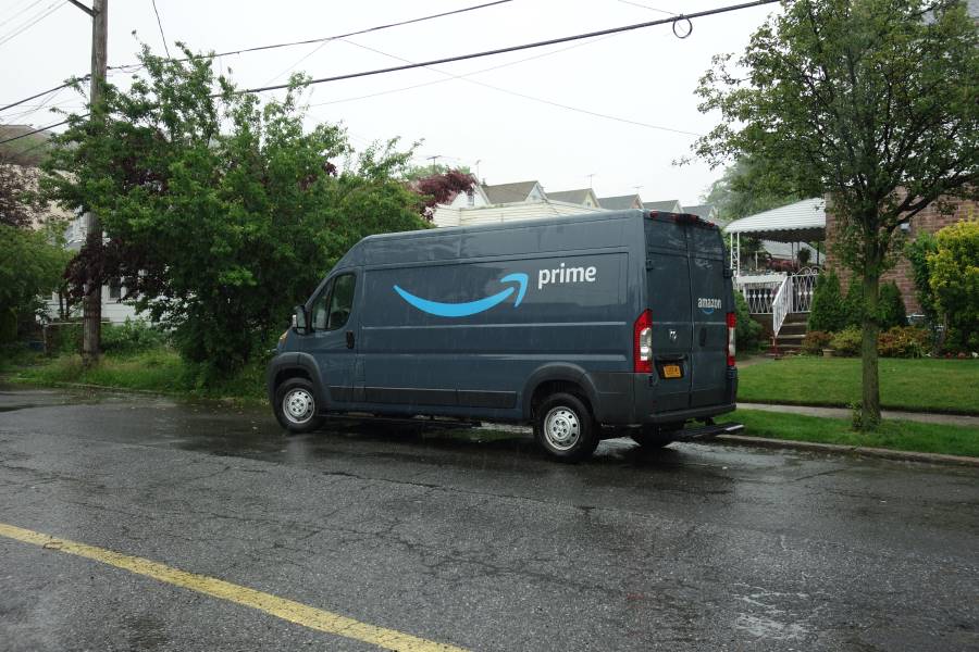 An Amazon delivery truck parked on a street.