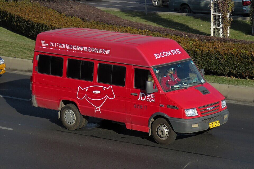 A red vehicle with JD.com branding on it.