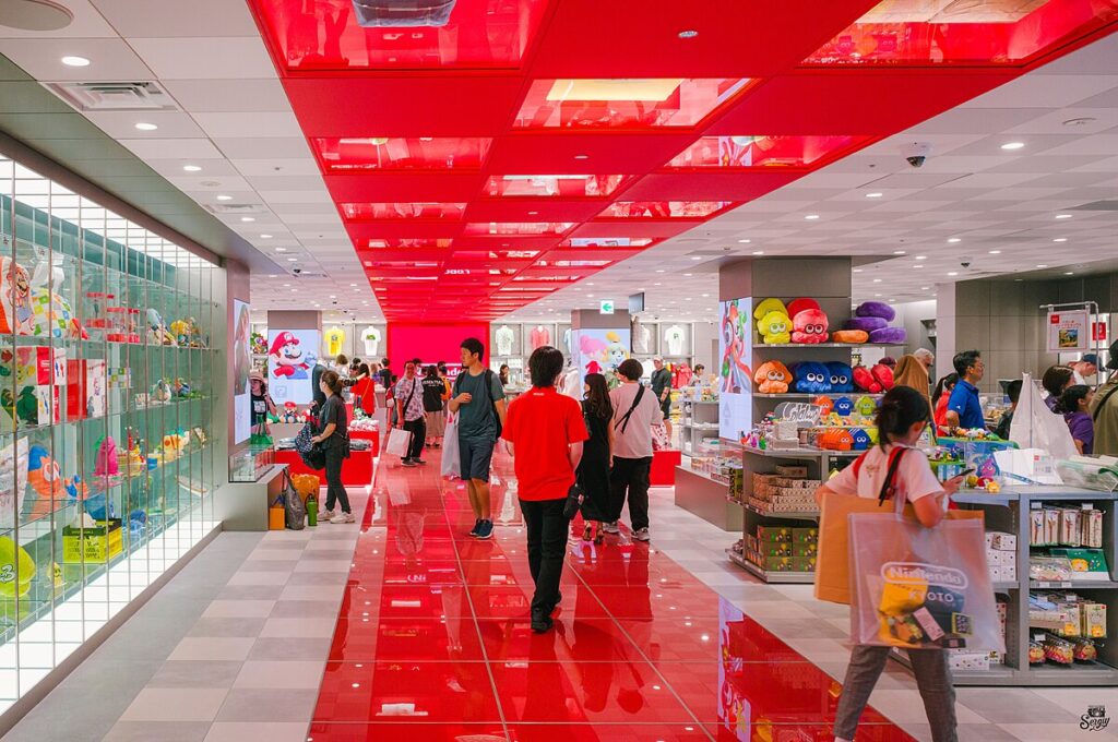 A busy Nintendo store with several people shopping