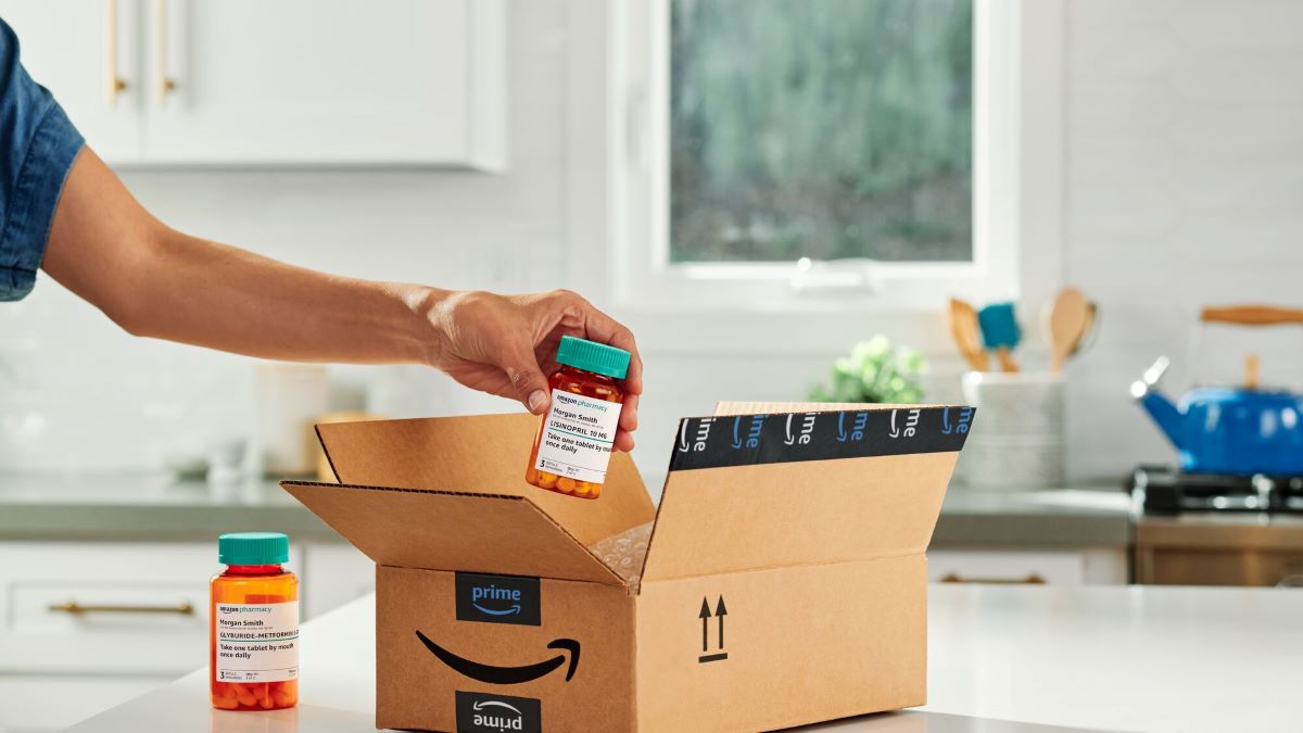 A person grabbing a prescription bottle from an Amazon box