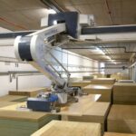 A robotic arm moving items in a warehouse