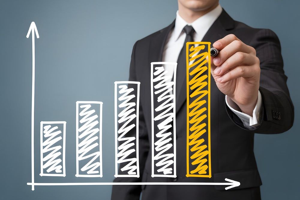 A person drawing a bar graph, with each bar being slightly taller than the last