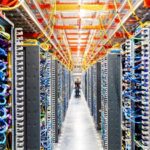 An image of a worker walking throughout a data center