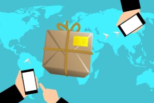 Two hands holding phones, with a package being sent from one person to another, and a world map as the background
