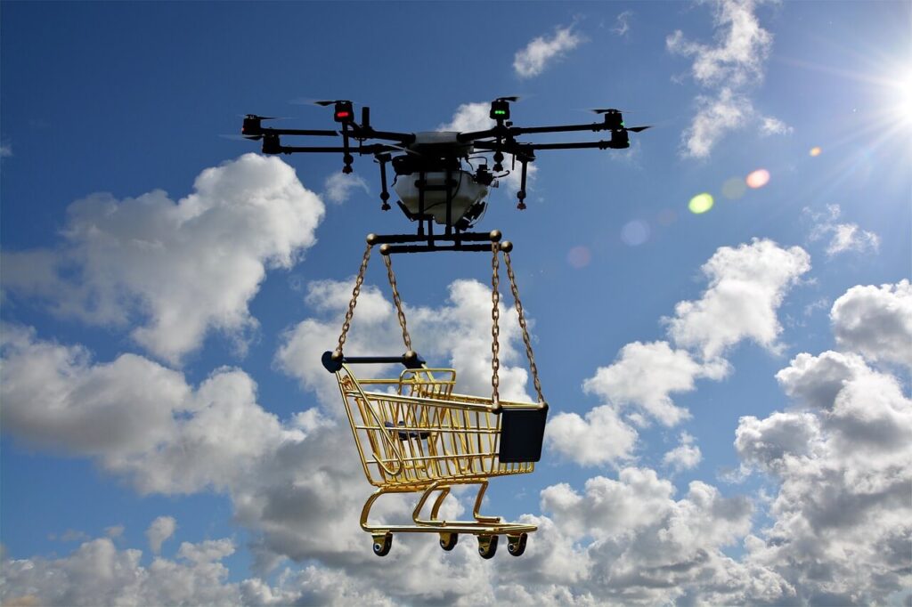 A drone flying through the sky, carrying a shopping cart.