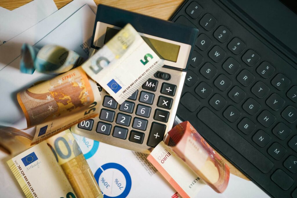 An image of a calculator on top of a laptop representing taxes