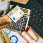 An image of a calculator on top of a laptop representing taxes