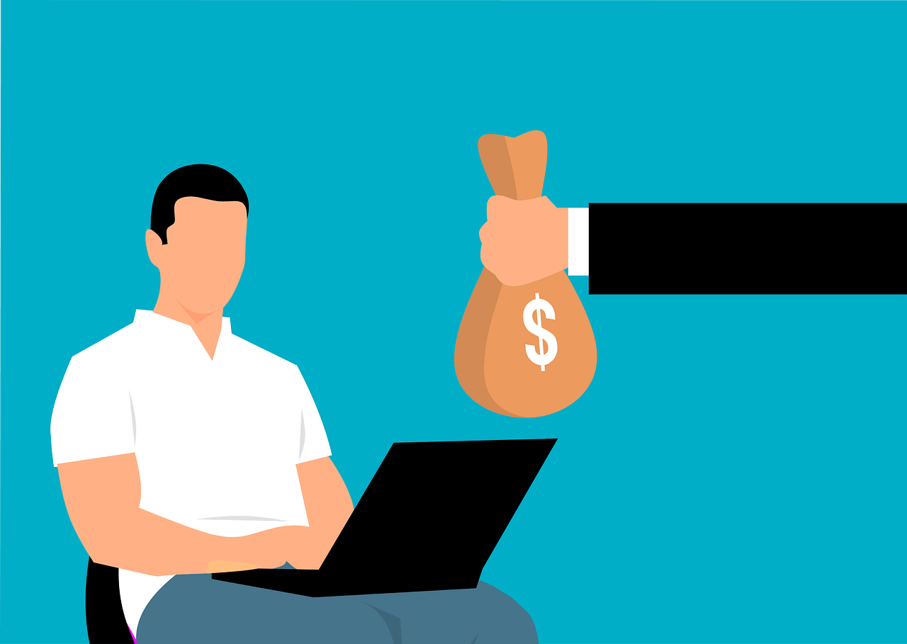 A person giving a bag of money to another person sitting on a chair using a laptop.