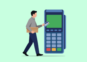 A person holding a box with a credit card in their other hand, walking towards a large card reader or terminal.