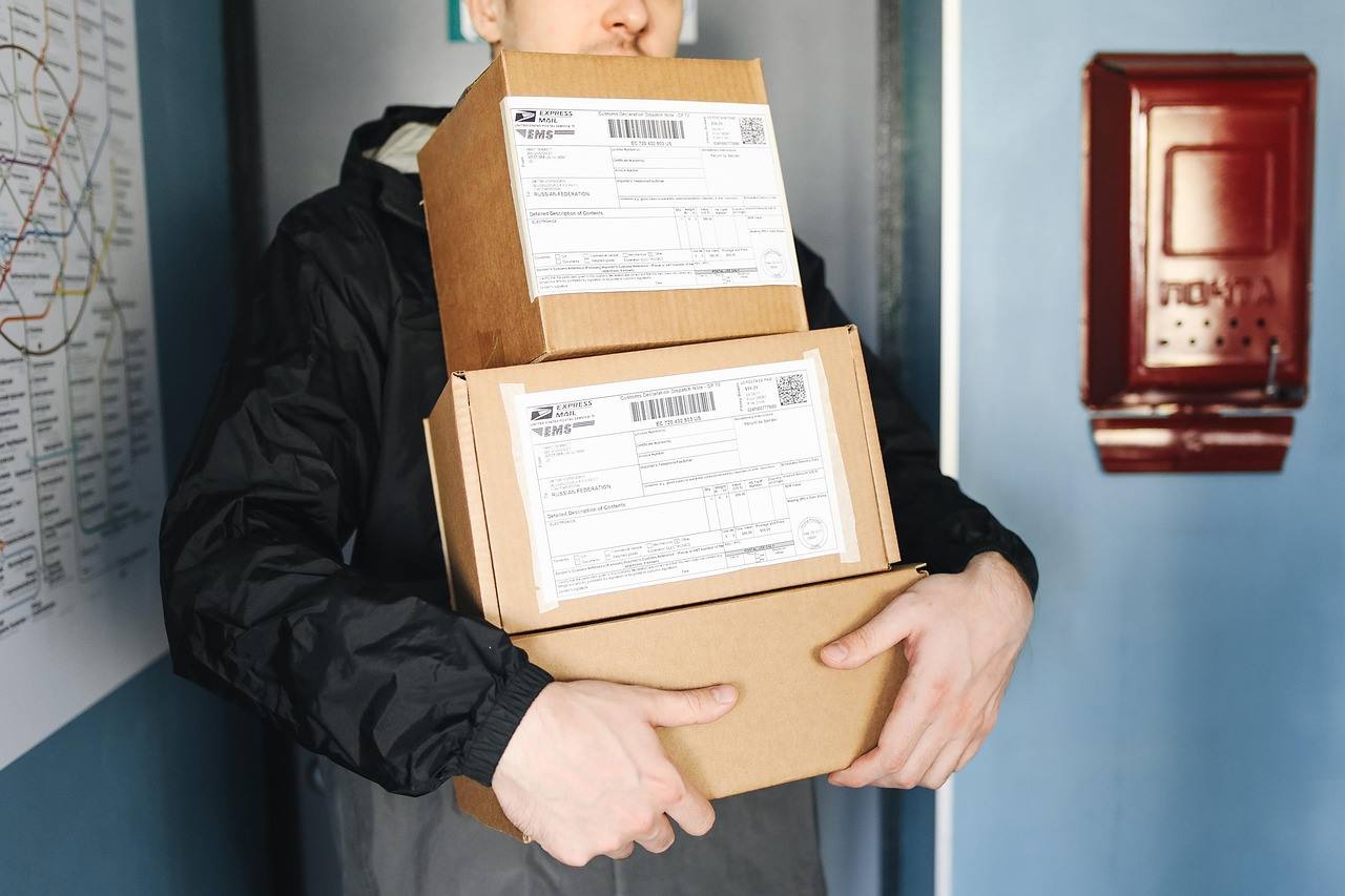 Person holding several packages in cardboard boxes