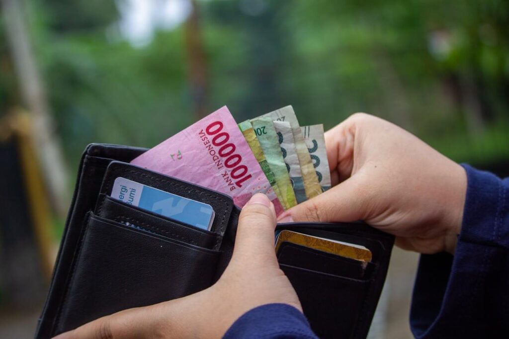 An image of a man representing small businesses opening his wallet