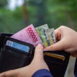 An image of a man representing small businesses opening his wallet