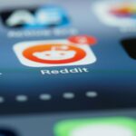 A close-up image of a phone screen with the Reddit app in clear view