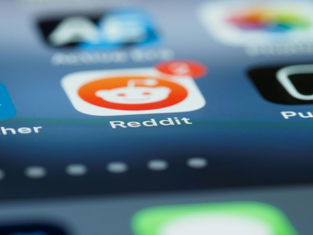 A close-up image of a phone screen with the Reddit app in clear view