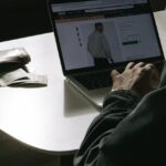 An image of a man on a laptop buying clothes