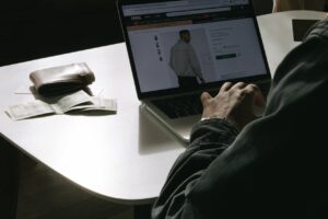 An image of a man on a laptop buying clothes