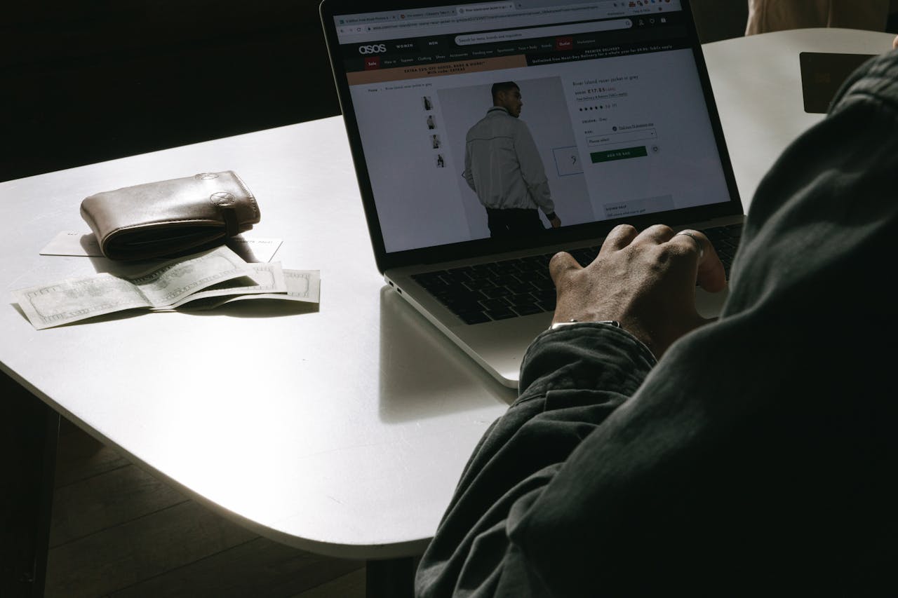 An image of a man on a laptop buying clothes