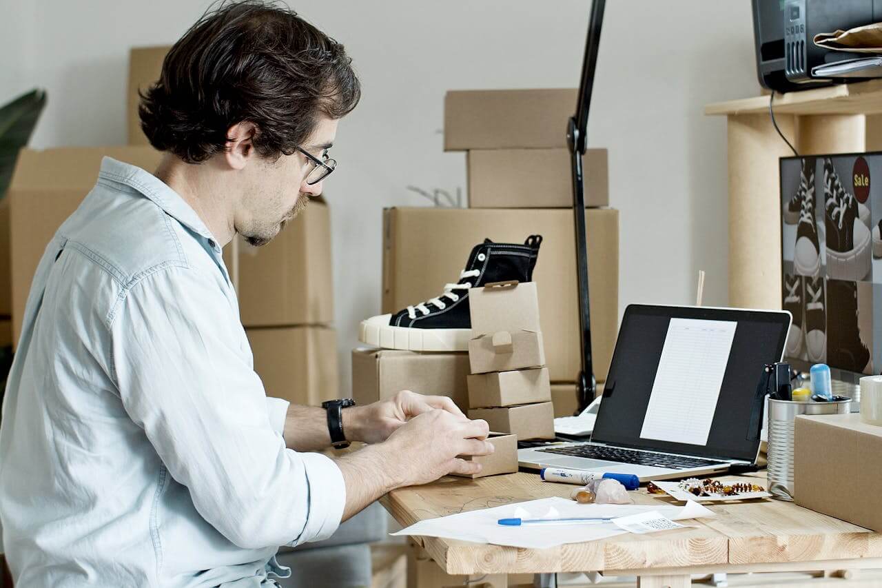 image of a guy working on his laptop and ecommerce platform