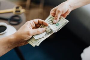 A person giving money to the other person