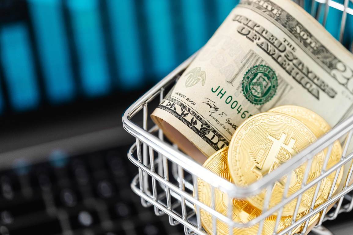 Bitcoin coins and cash in a cart