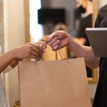 Two women with shopping bags.