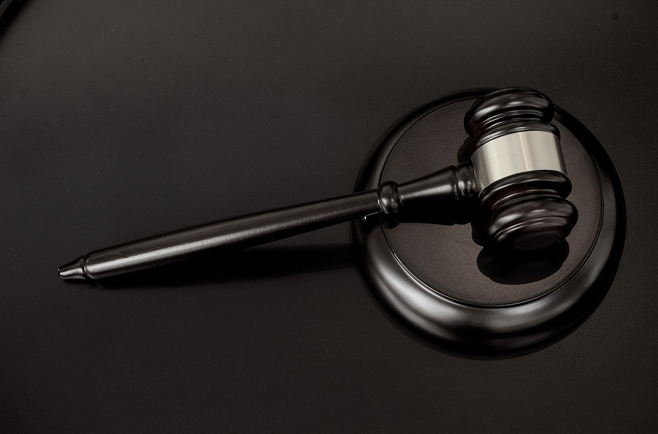 An image of a gavel lying on a sound block