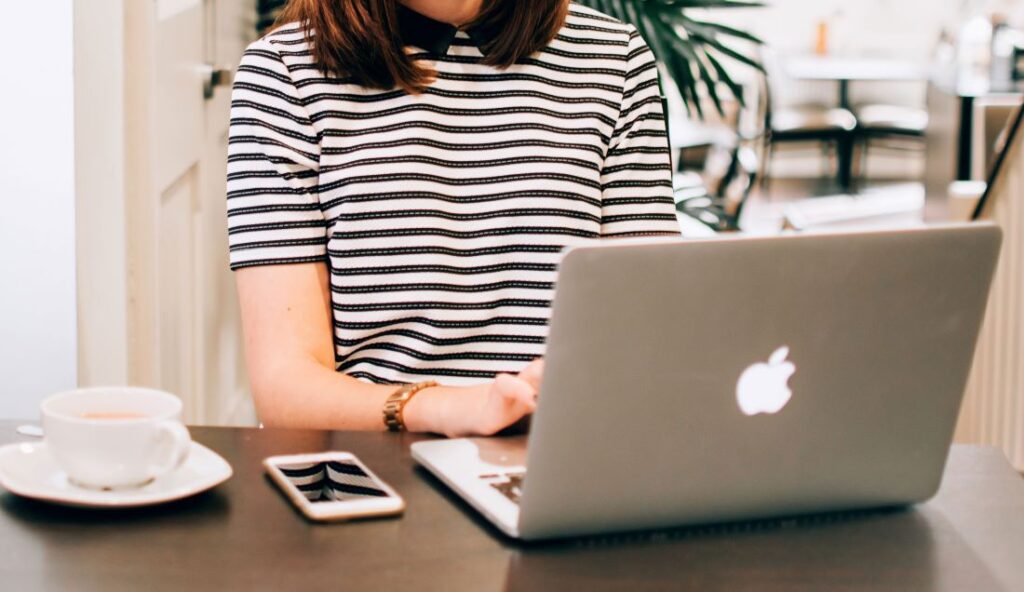A person sitting at a desk browsing their computer.