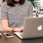 A person sitting at a desk browsing their computer.